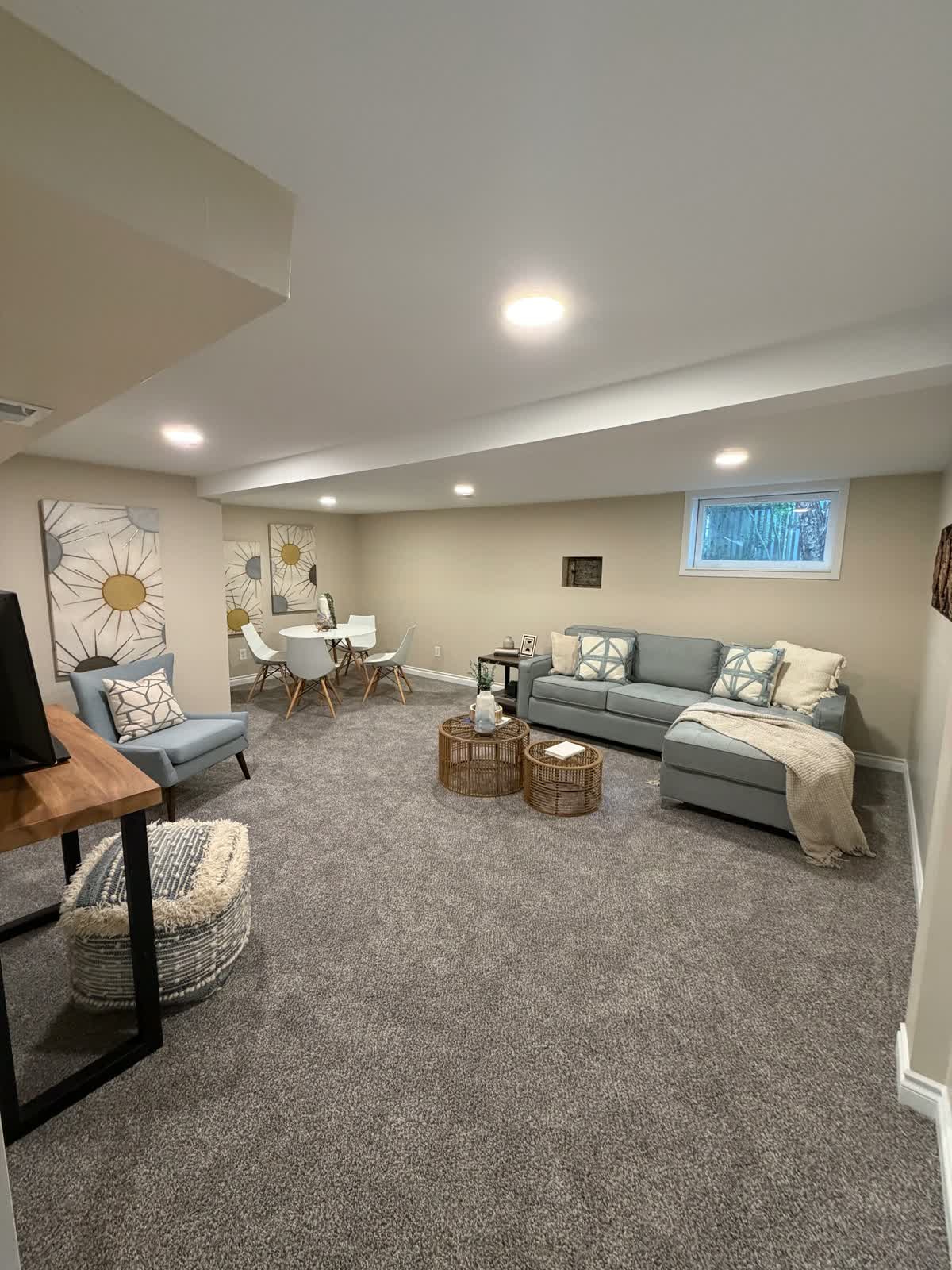 Finished basement living room with fresh paint and carpet